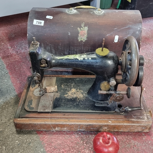 759 - A Victorian portable Singer sewing machine in domed hard case, with gilt and floral motifs. Branded ... 