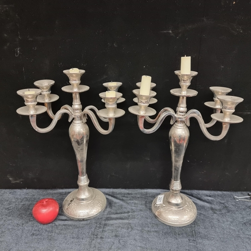A pair of five branch steel candelabras with an etched base and scroll arms. RRP €80.