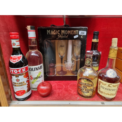 A selection of five spirits including Stock Vermouth, Molina Sambuka, Hennessy Cognac, Chivas Regal Whisky and Tio Nico Sherry, along with a Gift set of Freixenet Cordon Negro Brut Champagne with two branded glasses. Some of the bottles have been open.