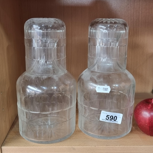 590 - Two cut glass decanters with matching glasses.