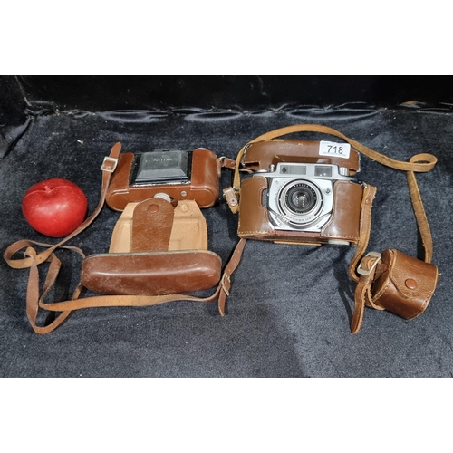 718 - Two vintage cameras including a Minolta A-2 rangefinder camera from 1955 in hard leather case and a ... 