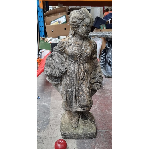 728 - A charming reconstituted stone and plaster garden statue of a lady holding a basket of flowers. With... 