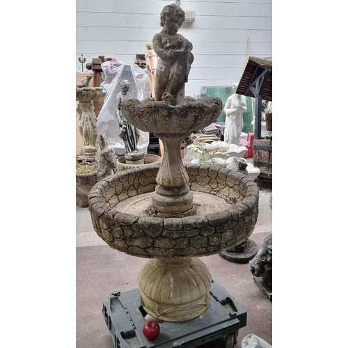 730 - A fantastic heavy, reconstituted stone and plaster fountain with a cherub to top. H130cm.