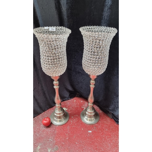 754 - Two tall candle Holders with crystal tops. Approx 70cm tall and very decorative.