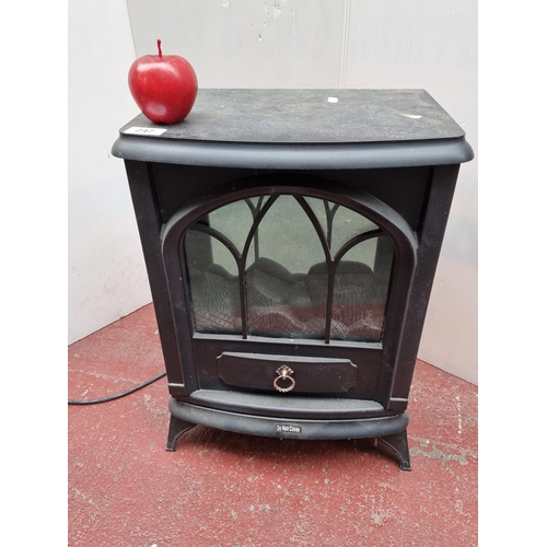 247 - An electric fireplace plug-in blow heater with light fixtures to emulate fire.