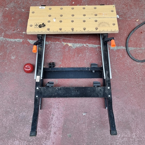 261 - A very useful worktable with ruler and protractor and several holes to the wooden top and steadfast ... 