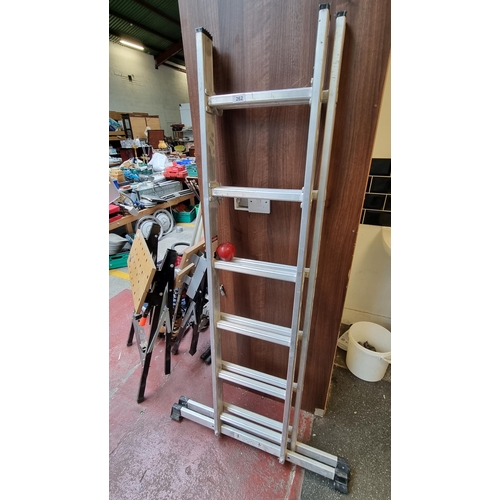 262 - A very tall useful foldable stainless steel ladder with 12 steps.