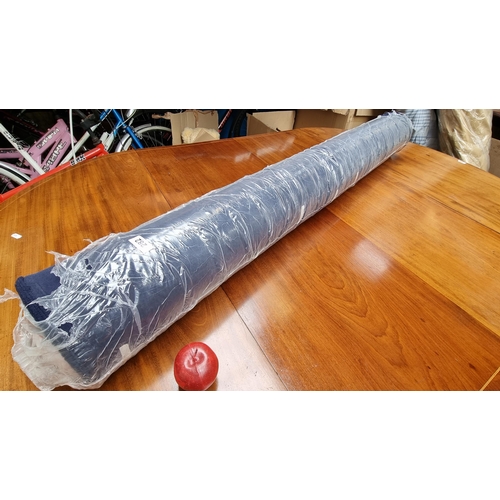 282 - A very large bolt of navy blue fabric.