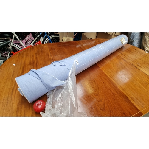 283 - A very large bolt of pale blue fabric in a linen blend.