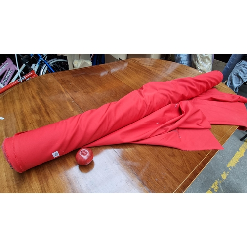 284 - A very large bolt of bright red fabric in a plain finish.