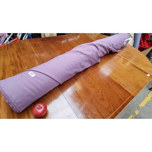 285 - A large bolt of lilac purple fabric in a plain finish