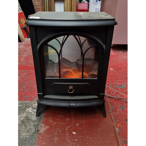 247 - An electric fireplace plug-in blow heater with light fixtures to emulate fire.