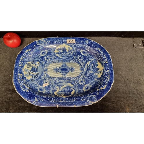 133 - A Large striking Victoria Ware Ironstone serving platter with a blue glaze pattern featuring pagoda ... 