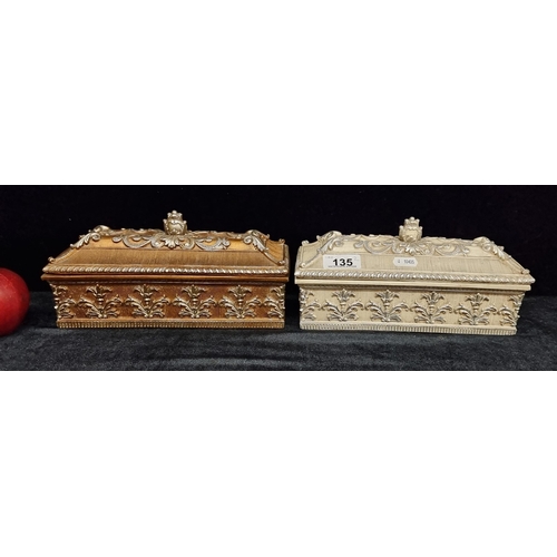 135 - Two pretty French-style jewellery boxes with relief foliate detail and bud finials. In a gilt and pe... 