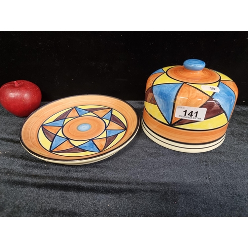 141 - A striking reproduction of a Clarice Cliff Bizarre cheese dome with geometric patterns in orange, bl... 