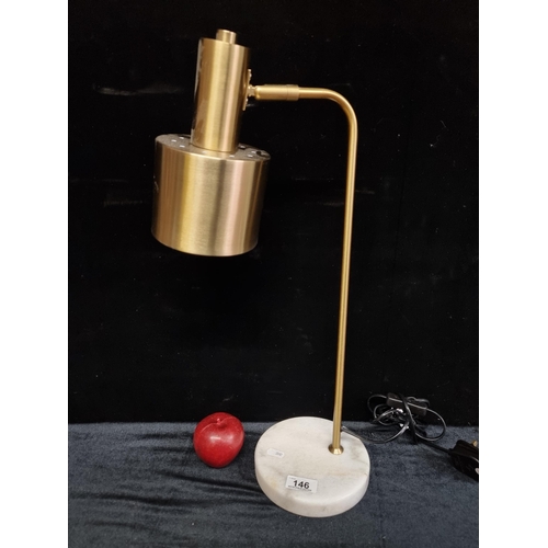 146 - A stylish and modern desk lamp with brushed brass toned stem and a heavy marble base.