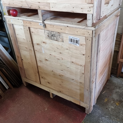 624 - A large wooden packing or storage crate with  hinged lockable top. H86cm x D68cm x L100cm (to base o... 