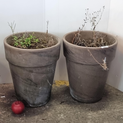 641 - A pair of stylish heavy ceramic planters with a stone coloured finish. H38cm, D31.5cm.