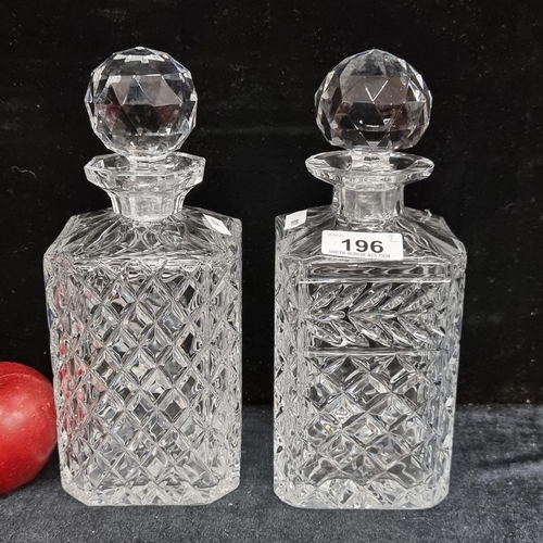 196 - Two very nice cut crystal decanters with accompanying stoppers. In good order.