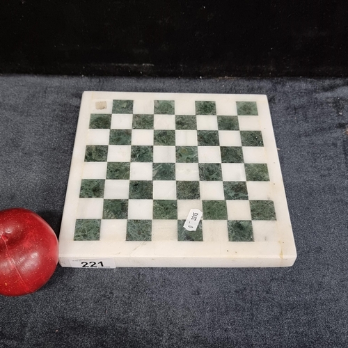 221 - A heavy white and green marble chessboard with purple felt base.