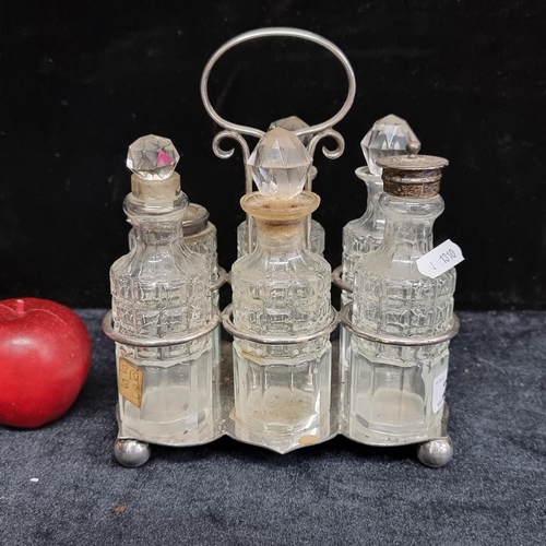 231 - An antique cruet set with silver EPNS frame and cut crystal bottles with stoppers.