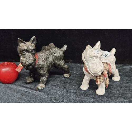 241 - Two vintage heavy cast iron scottie dog figures perfect as a door stop.