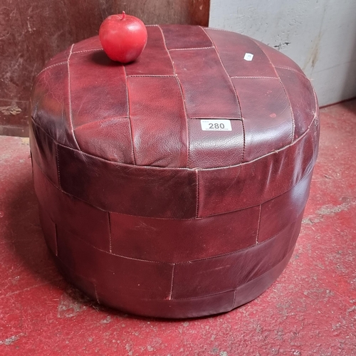 280 - A genuine leather mid century footstool in rich burgundy red leather after De Sede designs from the ... 