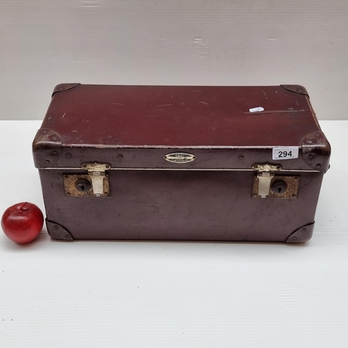 294 - A genuine leather travel case in a burgundy red finish with corner supports and leather carry handle... 