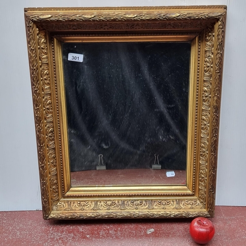 301 - A wall hanging-mirror encased in a beautifully carved, Victorian, gilded wood frame. Featuring oak l... 