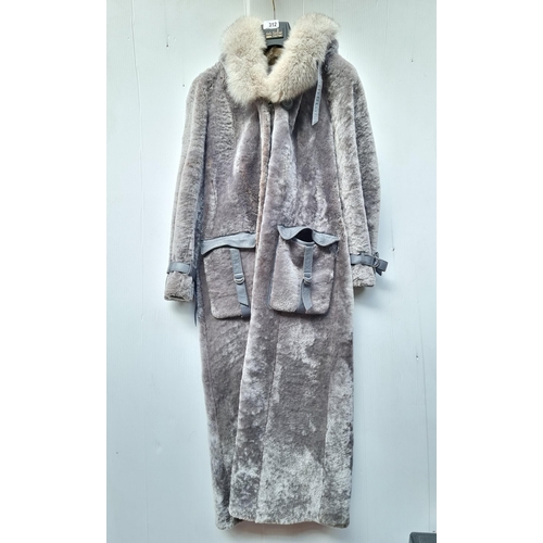 312 - A very attractive ladies long coat in faux fur. With an oversized hood and Inuit-style pockets. UK S... 