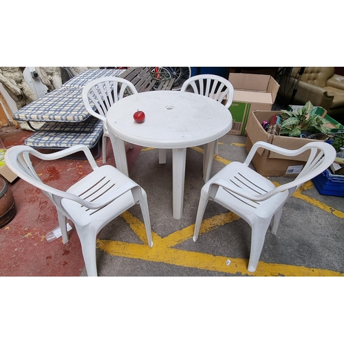 332 - A five piece garden furniture suite comprising of a circular table with four matching chairs. All in... 