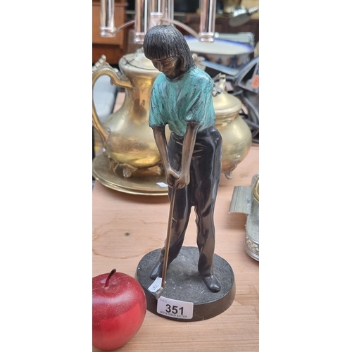 351 - A vintage cast bronze figurine, depicting a lady golfer with a mint green top.