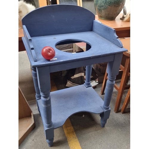 A Victorian wash stand with turned legs and tall gallery back. Refinished in a royal blue shade. A funky addition to any home.