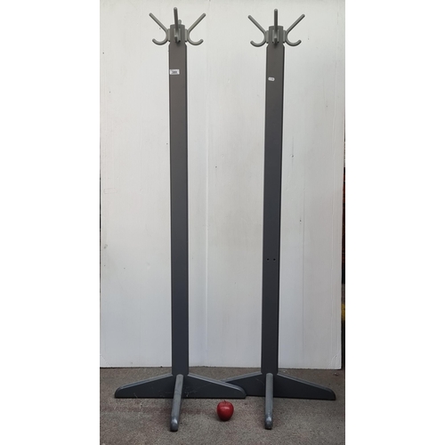 380 - A matching pair of freestanding coat racks, in shades of grey. H165cm.