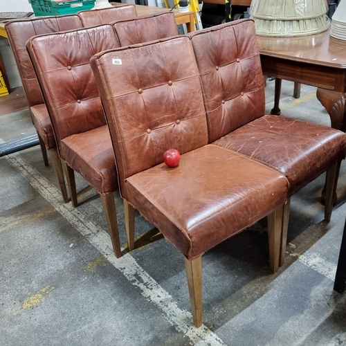 462 - A suite of six beautiful dining chairs upholstered in a genuine tan leather, with button back detail... 