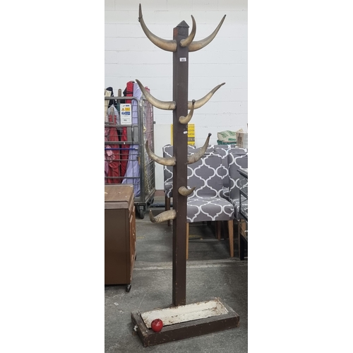 463 - An unusual vintage  floor standing cow horn coat rack, which, with drip basin to base. H185cm. Super... 