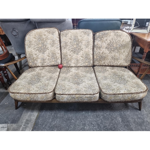 476 - Star Lot : A beautiful 1978 Ercol Windsor three seater sofa with very finely turned supports and sty... 