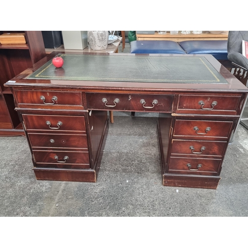 479 - Star Lot : A handsome twin pedestal desk with tooled green leather inlay, ample storage by way of tw... 