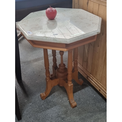 483 - An elegant marble topped octagonal wash stand, on a finely turned wooden base.