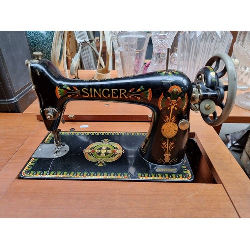 372 - A teak sewing machine table, complete with a beautifully painted 