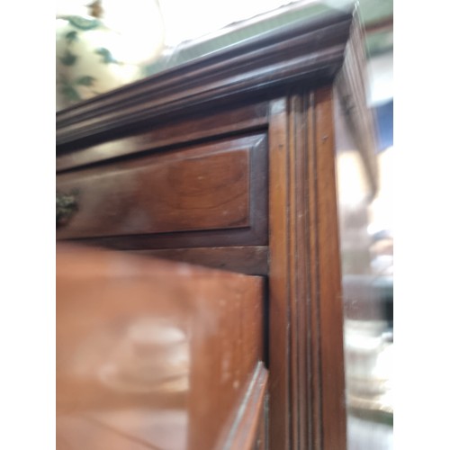 411 - A handsome Edwardian sideboard with two drawers and two cupboards with brass drop handles. Decorated... 