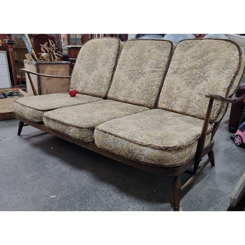 476 - Star Lot : A beautiful 1978 Ercol Windsor three seater sofa with very finely turned supports and sty... 