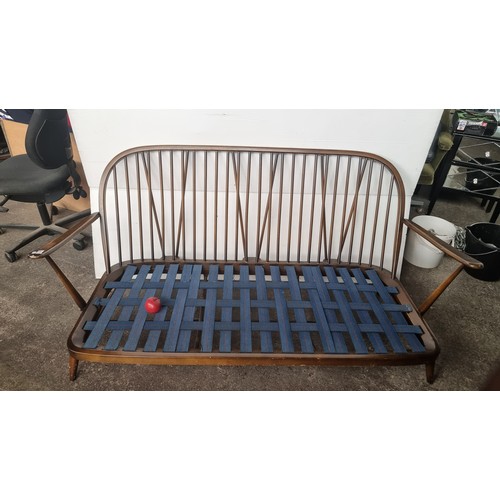 476 - Star Lot : A beautiful 1978 Ercol Windsor three seater sofa with very finely turned supports and sty... 