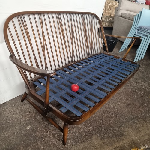 476 - Star Lot : A beautiful 1978 Ercol Windsor three seater sofa with very finely turned supports and sty... 