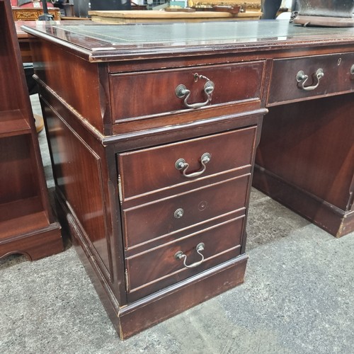 479 - Star Lot : A handsome twin pedestal desk with tooled green leather inlay, ample storage by way of tw... 