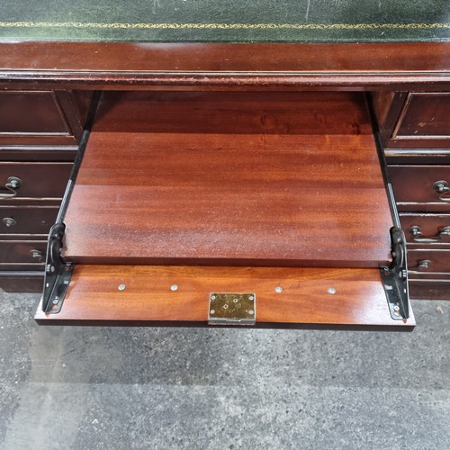 479 - Star Lot : A handsome twin pedestal desk with tooled green leather inlay, ample storage by way of tw... 