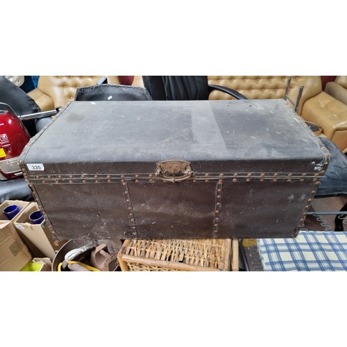 335 - A heavy wooden chest filled with a selection of tools including screwdrivers, hammers, hand saws and... 