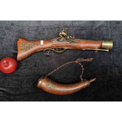 110 - A replica French Blunderbuss pistol with genuine wood grip and flintlock. Accompanied by a mahogany ... 