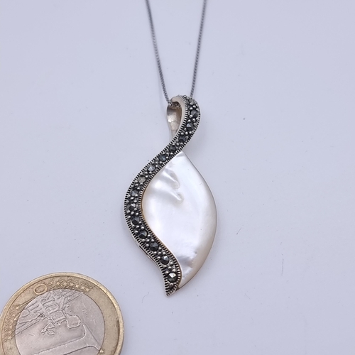 12 - A striking leaf design sterling silver pendant necklace, set with a lovely Mother of Pearl accent wh... 