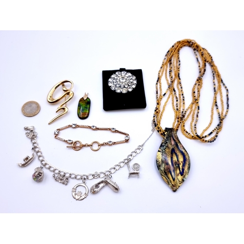 13 - A collection of six jewellery items, including a sterling silver seven charm bracelet. Weight: 21.9 ... 